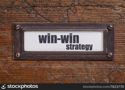 win-win strategy - file cabinet label, bronze holder against grunge and scratched wood
