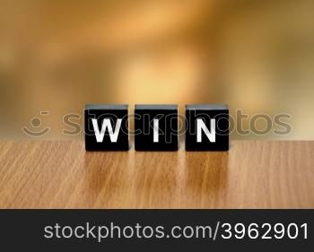 win, winner on black block with blurred background