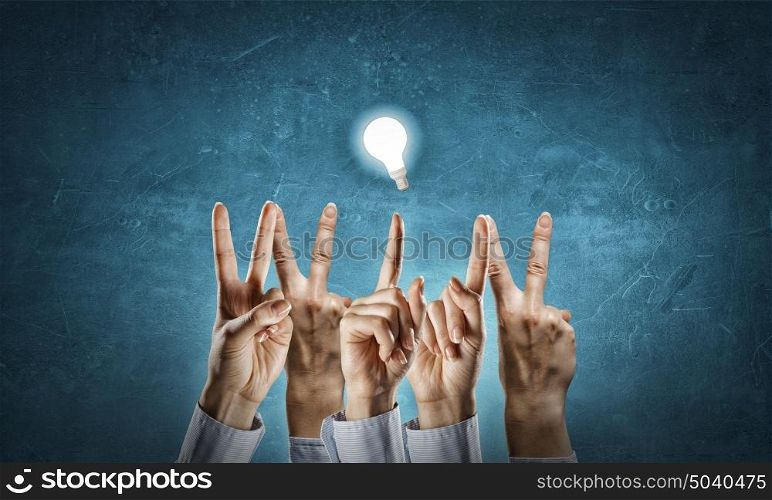 WIN word. Word WIN with fingers and glowing light bulb