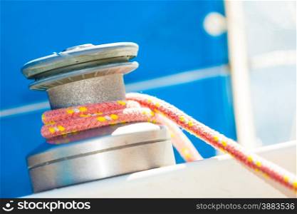Winch capstan with rope on sailing boat. Yachting yacht in blue baltic sea sunny day summer vacation. Tourism luxury lifestyle.