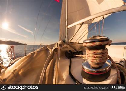 Winch with rope on sailing boat in the sea at sunset&#xA;
