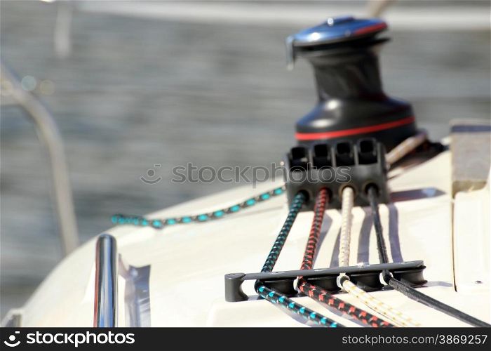 Winch with rope on sailing boat. Yacht detailed parts. Yachting Baltic sea summer vacation. Tourism luxury lifestyle.