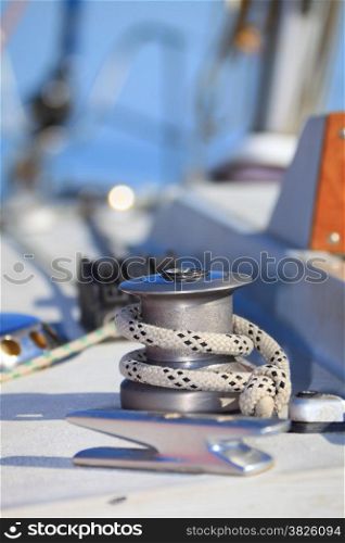 Winch with rope on sailing boat. Yachting yacht in blue baltic sea sunny day summer vacation. Tourism luxury lifestyle.
