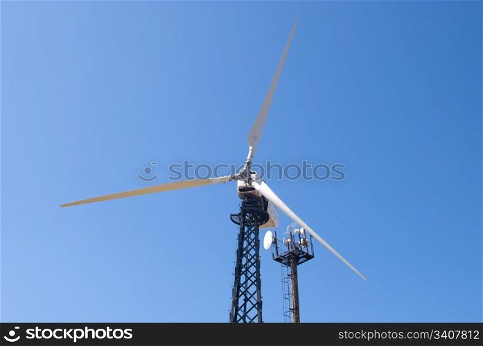 wind energy, modern white wind turbine or wind mill producing energy to power a city