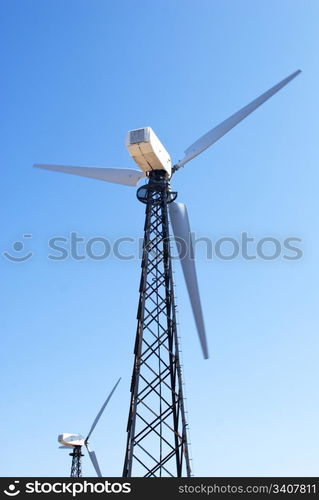 wind energy, modern white wind turbines in motion producing energy to power a city