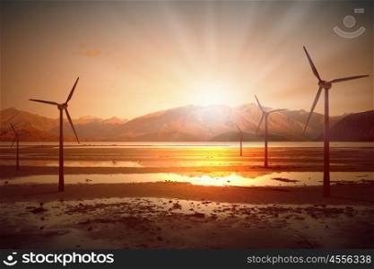 Wind energy. Some windmills standing in desert. Power and energy concept