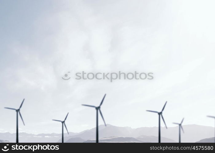 Wind energy. Some windmills standing in desert. Power and energy concept