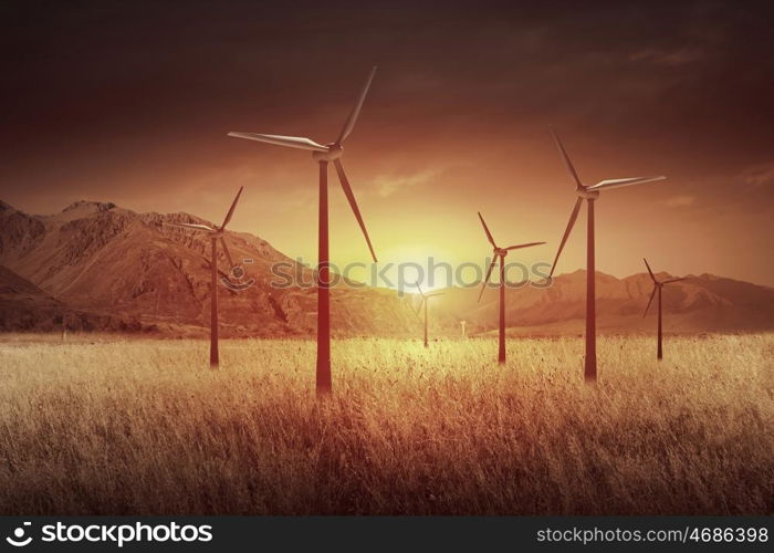 Wind energy. Some windmills standing in desert. Power and energy concept