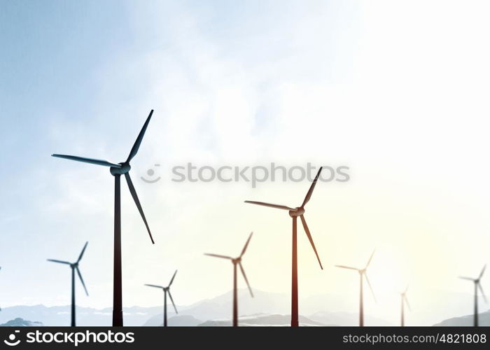 Wind energy. Some windmills standing in desert. Power and energy concept