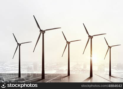 Wind energy. Some windmills standing in desert. Power and energy concept