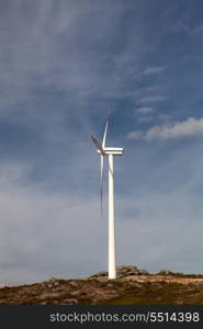 Wind energy turbine, isolated over a beautiful blue sky