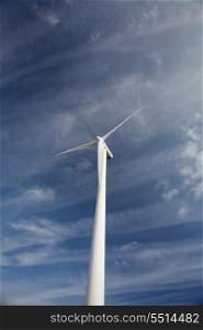 Wind energy turbine, isolated over a beautiful blue sky