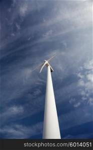 Wind energy turbine, isolated over a beautiful blue sky