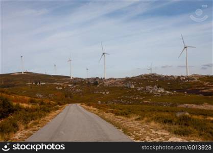 Wind energy turbines, in a landscpae over a beautiful blue sky
