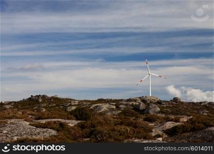 Wind energy turbines, in a landscpae over a beautiful blue sky