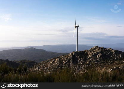 Wind energy turbines, in a landscpae over a beautiful blue sky