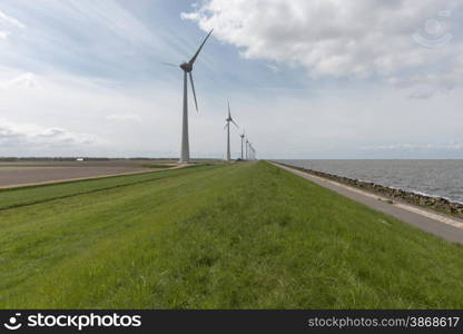 Wind farm along the dike of the noordoostpolder in the Netherlands
