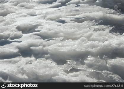 Wind form ice texture on winter mountain snow surface