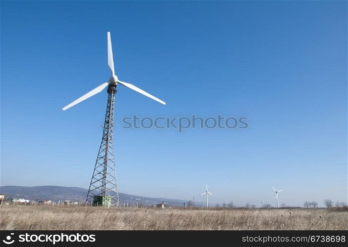 Wind generators on blue sky.