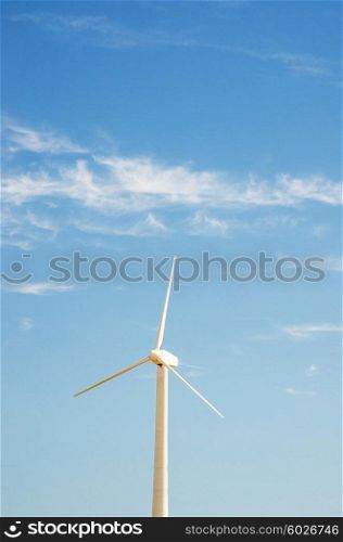 Wind mill on the bright summer day