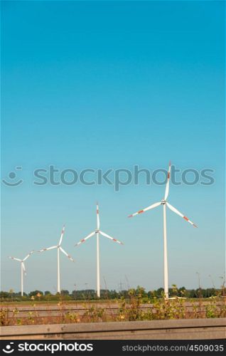 Wind mills during bright summer day