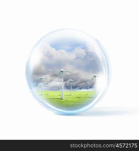 wind power. A group of wind turbines or windmills inside a glass sphere