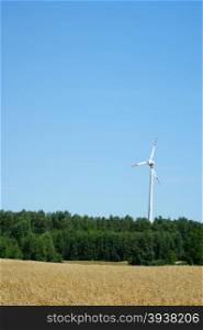 Wind power turbine blue sky and fields of corn