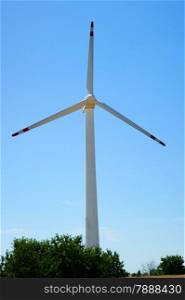 Wind power turbine, forest - blue sky