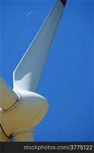Wind power - turbine installation with blue sky and moon
