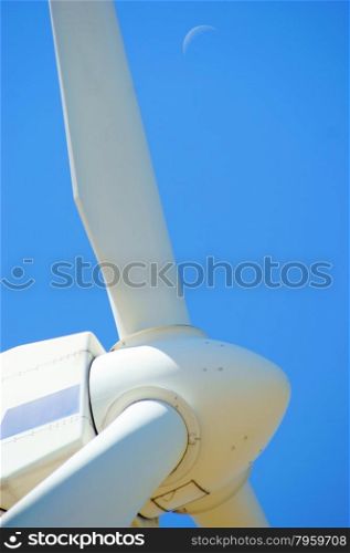 Wind power - turbine installation with blue sky and moon