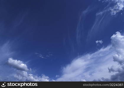Wind Swept Clouds In A Clear Blue Sky