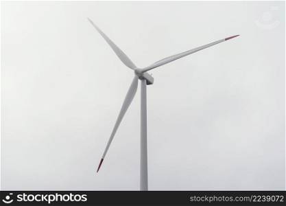 wind turbine against cloudy sky