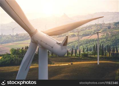 Wind turbine farm power generator in beautiful nature landscape for production of renewable green energy is friendly industry to environment. Concept of sustainable development technology.