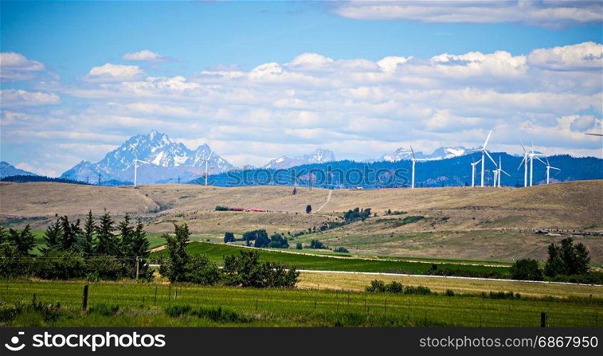 wind turbine farm with wenatchee mountains in the background