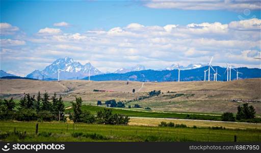 wind turbine farm with wenatchee mountains in the background