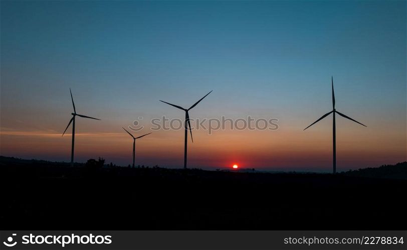 wind turbine field at beautiful sunset sky background. renewable energy