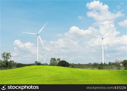Wind Turbine for alternative energy iwith green grass fields forground. Eco power, clean energy concept.
