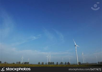 wind turbine generating eco friendly renewable electricity energy on blue sky