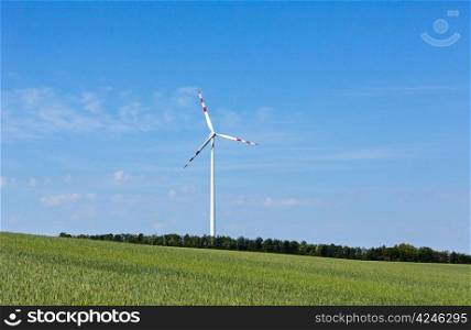 Wind turbine on blue sky background