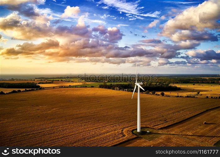 wind turbine power generator on a field in harmonic mood atmosphere