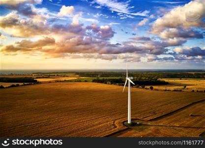 wind turbine power generator on a field in harmonic mood atmosphere