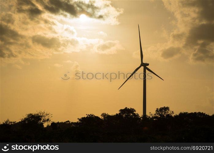 Wind turbine power. Large wind turbine generates electricity. In the sunset