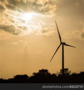 Wind turbine power. Large wind turbine generates electricity. In the sunset