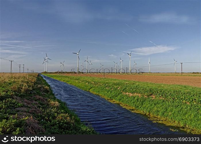 Wind turbines and drainage dyke in Lincolnshire,UK. HDR Image