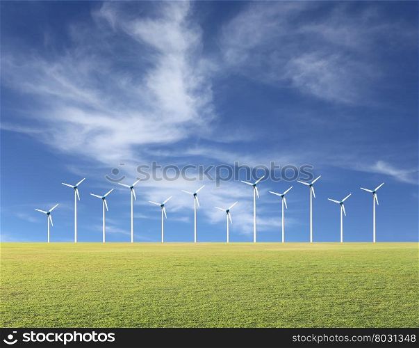 Wind turbines and green lawn on a blue sky day,concept of using alternative energy.