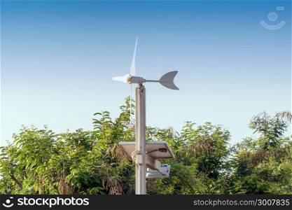 Wind turbines and Solar panels with Green energy Concept in the morning