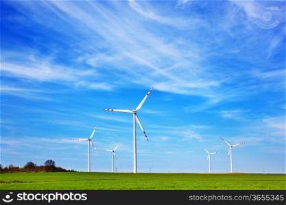 Wind turbines farm. Blue cloudy sky. Alternative eco source of energy