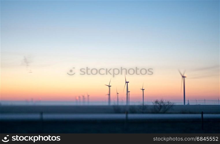wind turbines farm field at sunrise