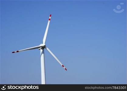 Wind turbines farm on a clear blue sky. Alternative energy source.