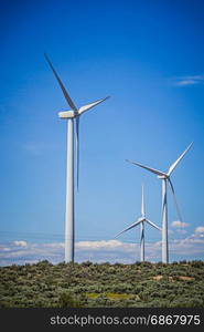 wind turbines generating electricity on a windy sunny day